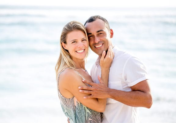 A couple embracing each other on the beach